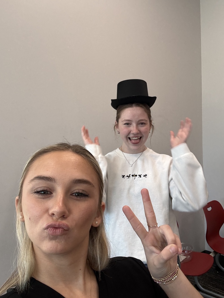 Students posing in a hat