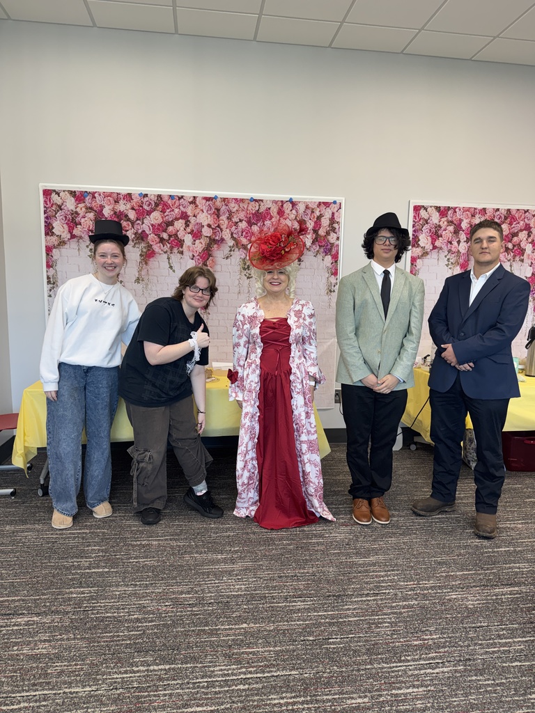 Students and teacher dressed for the Tea Party