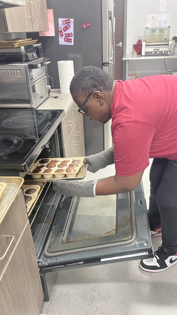 Student getting brownies out of oven