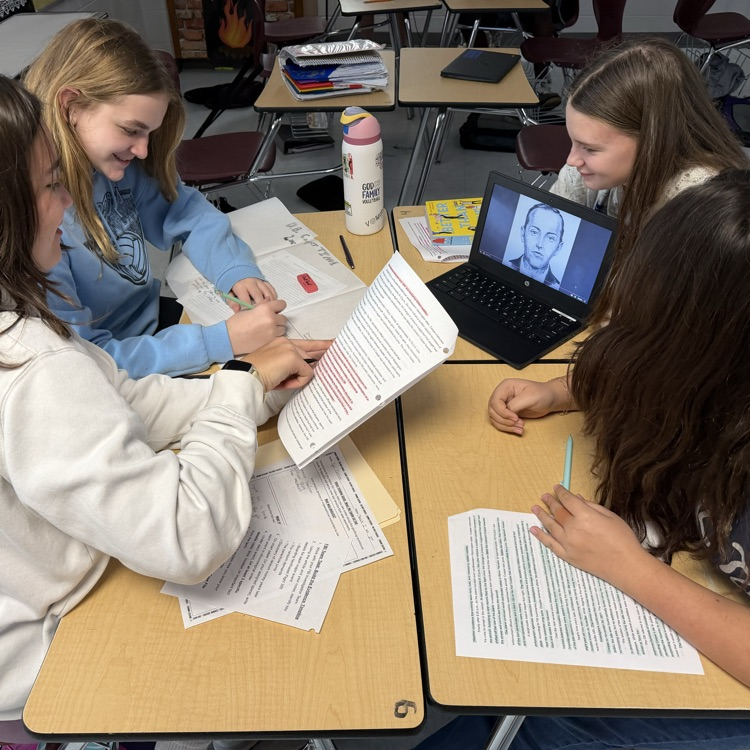 students working on research for podcast 