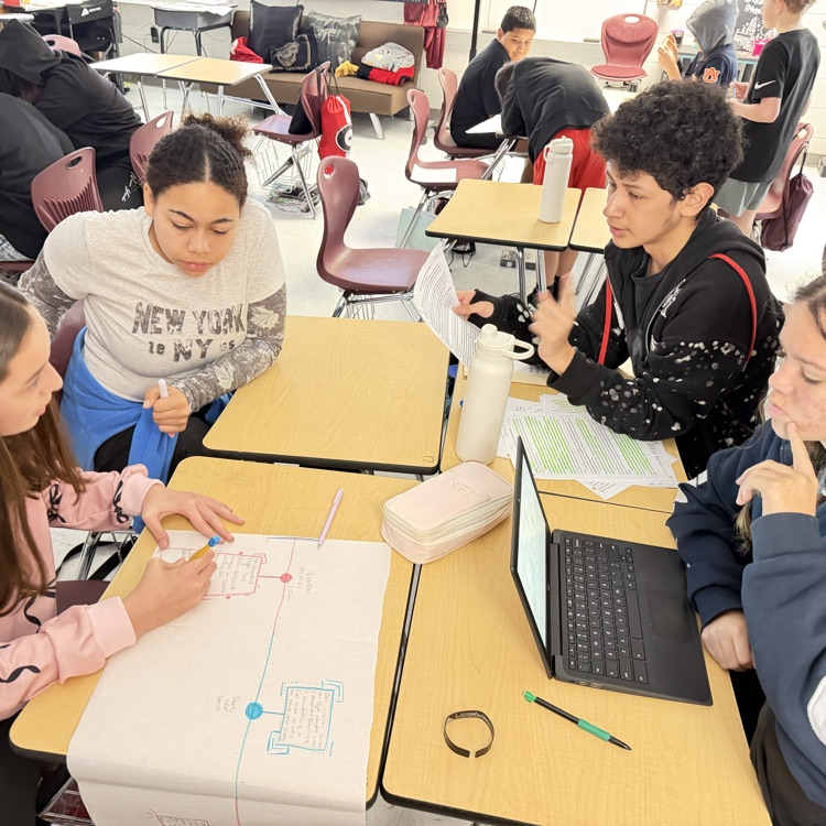 students working on research for podcast 