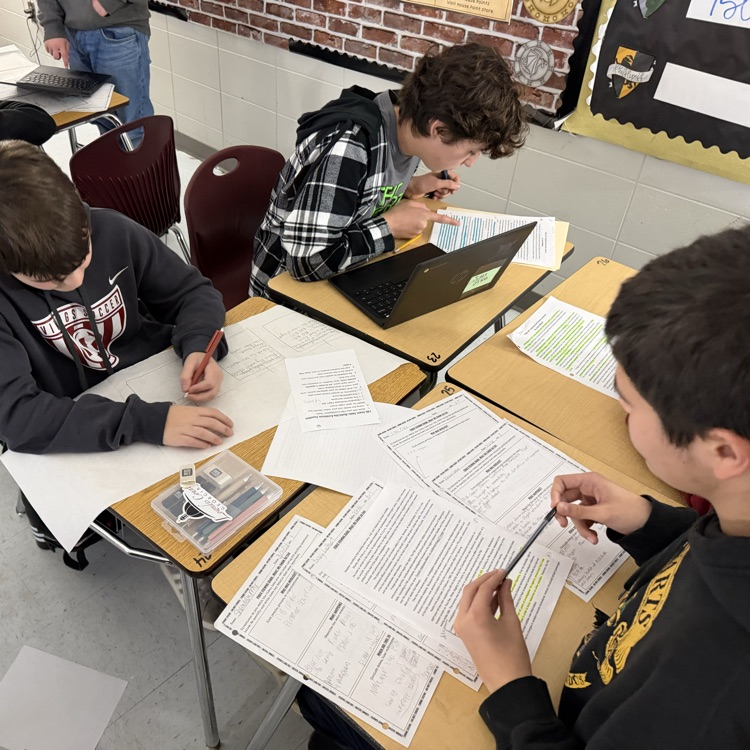 students working on research for podcast 