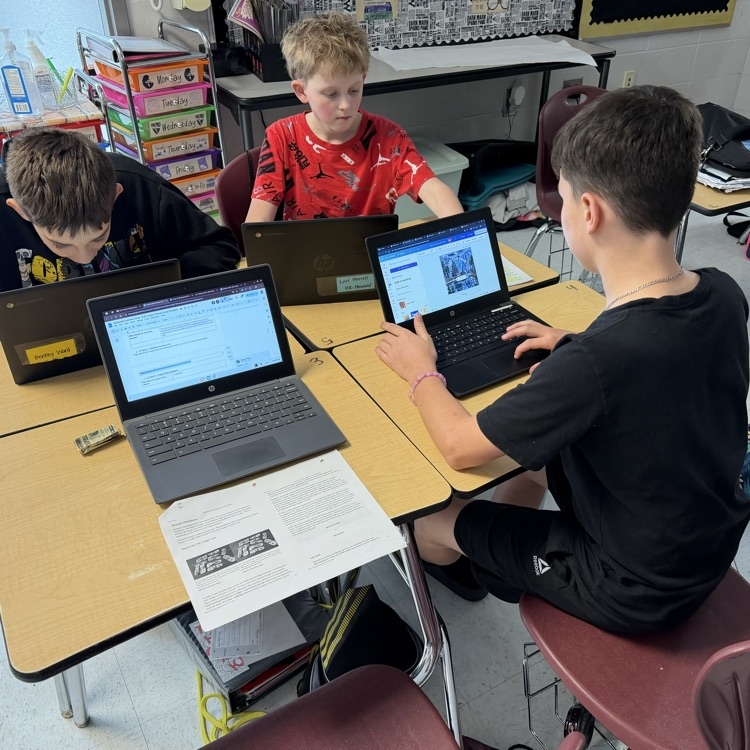 students working on research for podcast 