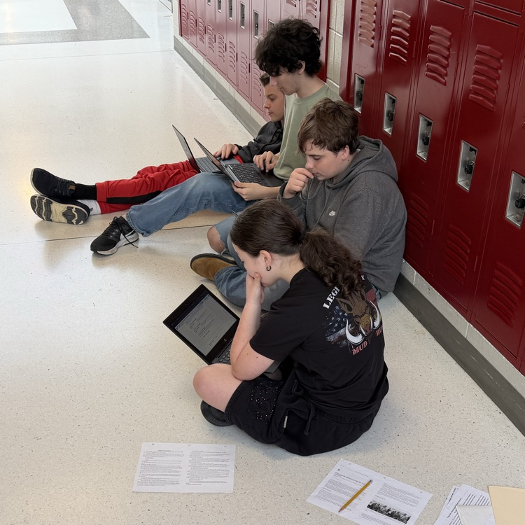 students working on research for podcast 