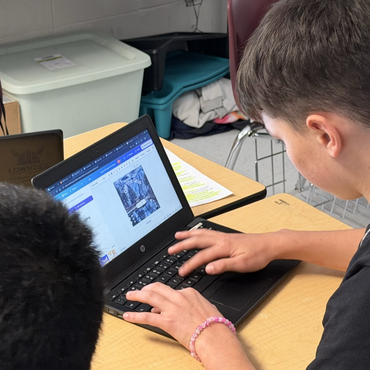 students working on research for podcast 