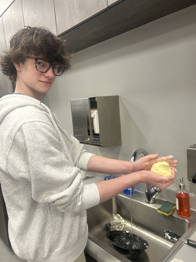 Student holding a ball of fresh butter