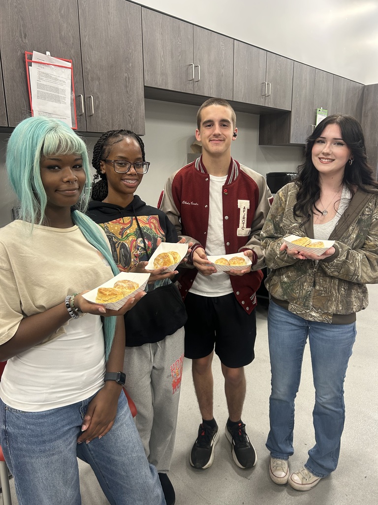 Students with the biscuits they baked.