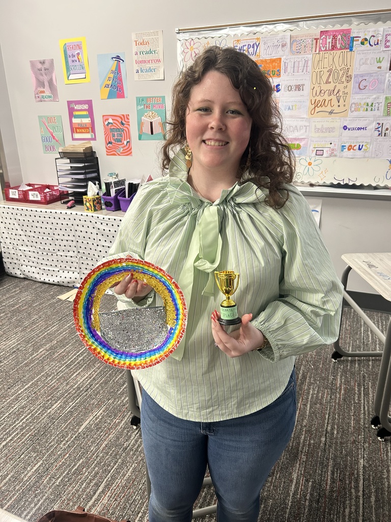 Student with small gold trophy and artwork