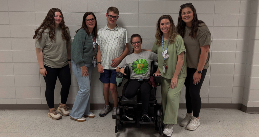 Students and teachers in green