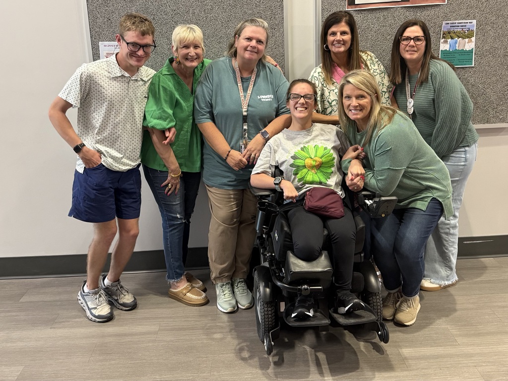 Students and teachers in green