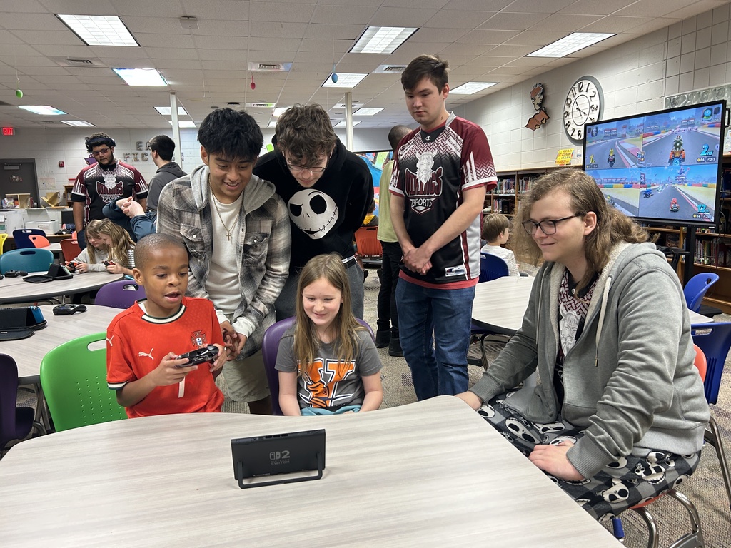 eSports members cheering on elementary players