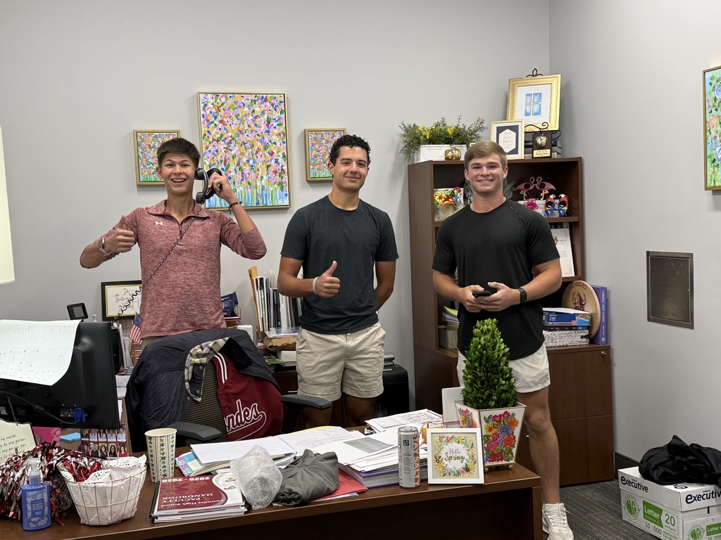 Morning announcement crew smiling and giving a thumbs up.
