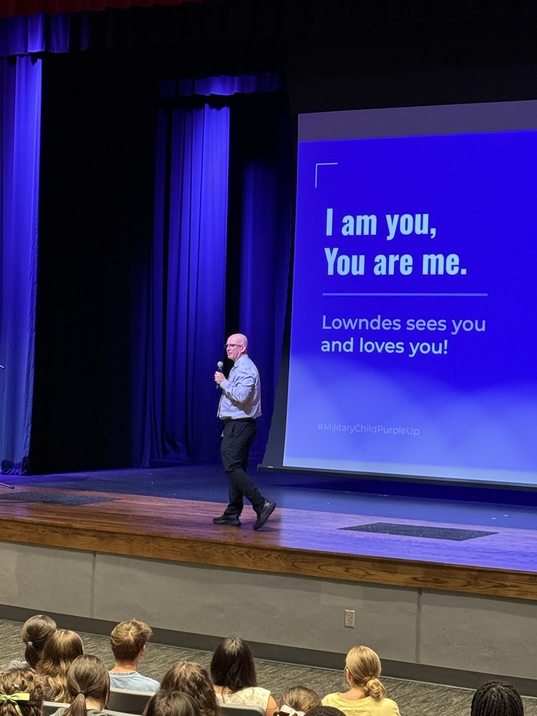 Speaker on stage at assembly