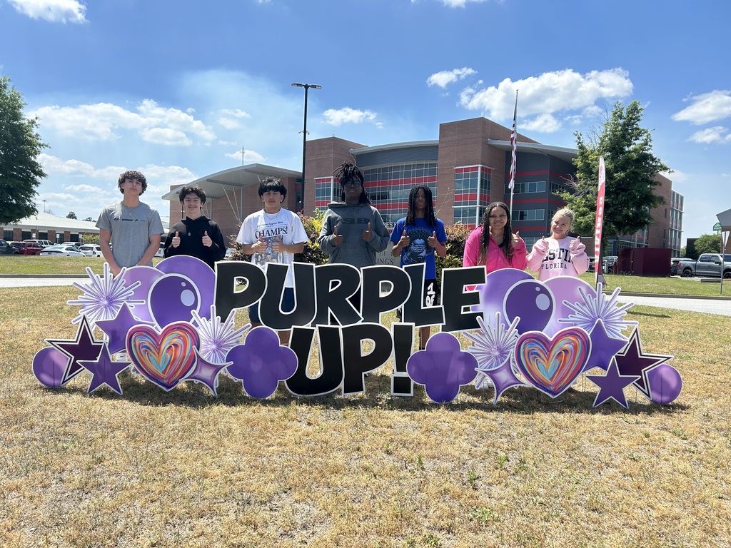 Seven of our military-connected students with the Purple Up! sign