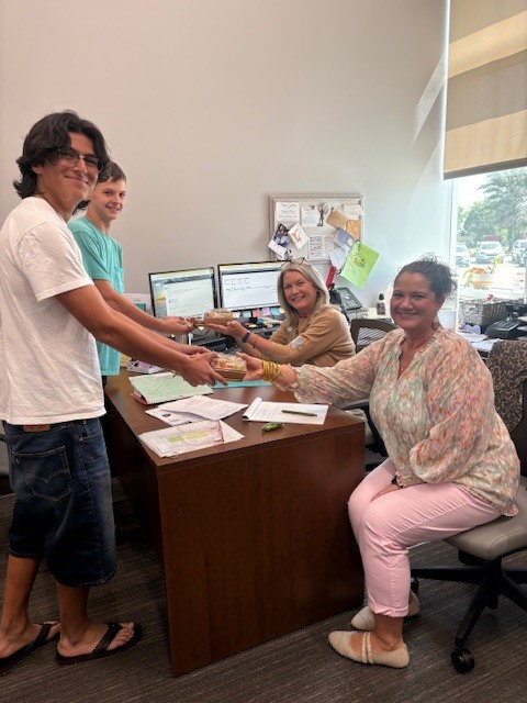 Students delivering gifts to administrative assistants