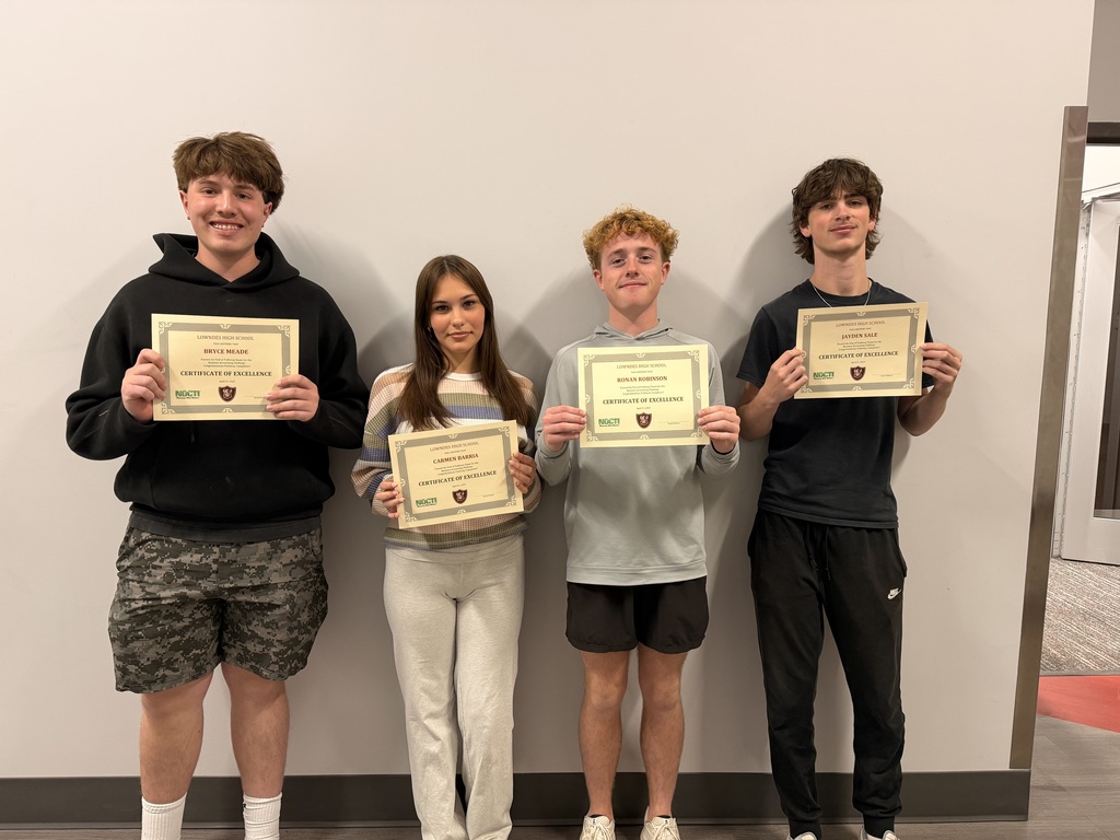 Four students with their end of pathway completion certificates.