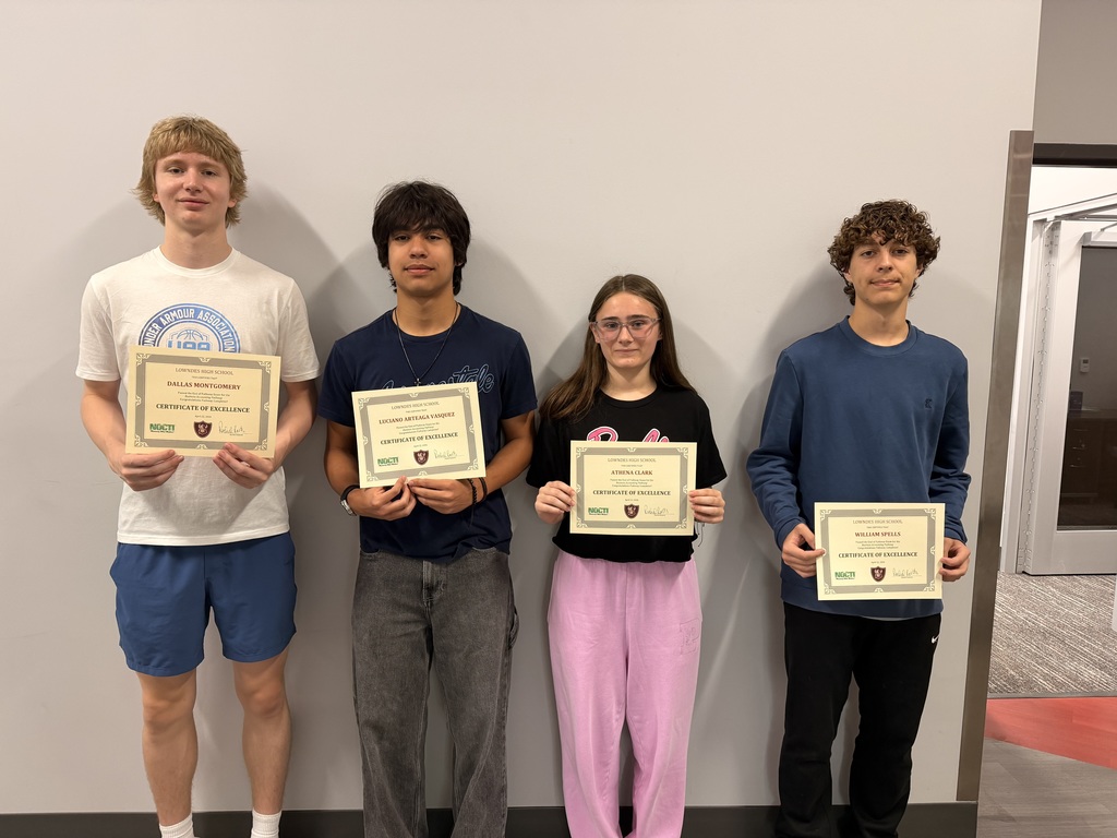 Four students with their end of pathway completion certificates.