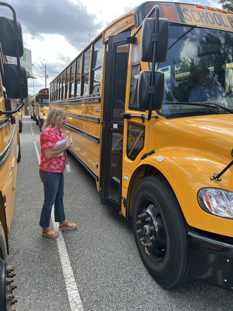 Teacher handing out gifts and telling bus drivers Thank you!