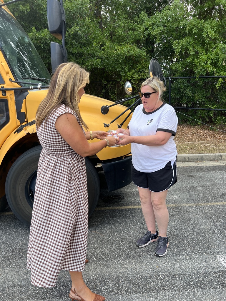 Teacher giving bus driver a gift
