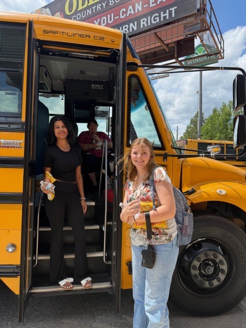 Students giving chips and water  to a bus driver