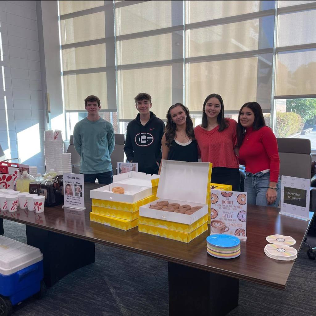 Students serving donuts and coffee