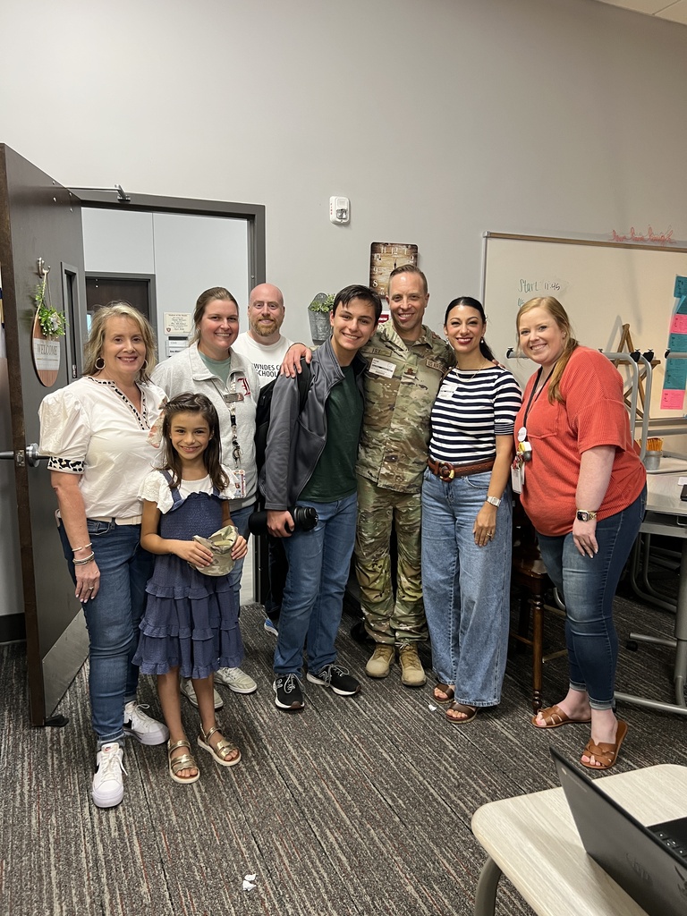 Logan with family, teachers, and school administrators