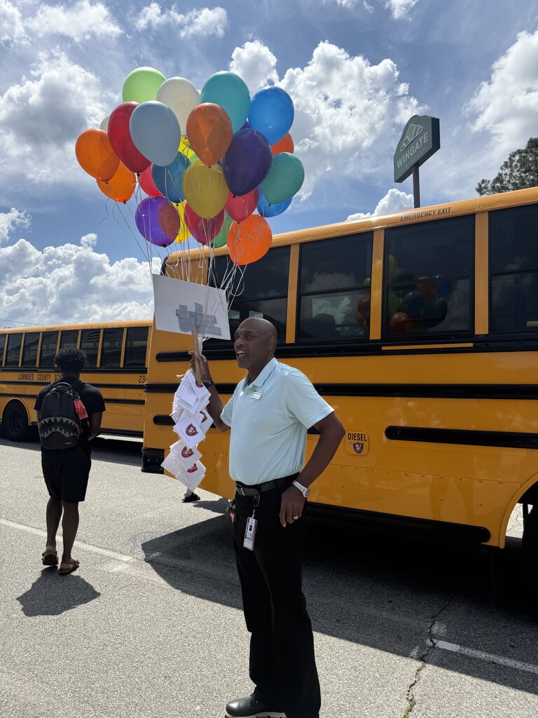 Mr. Walker at bus duty with his balloons