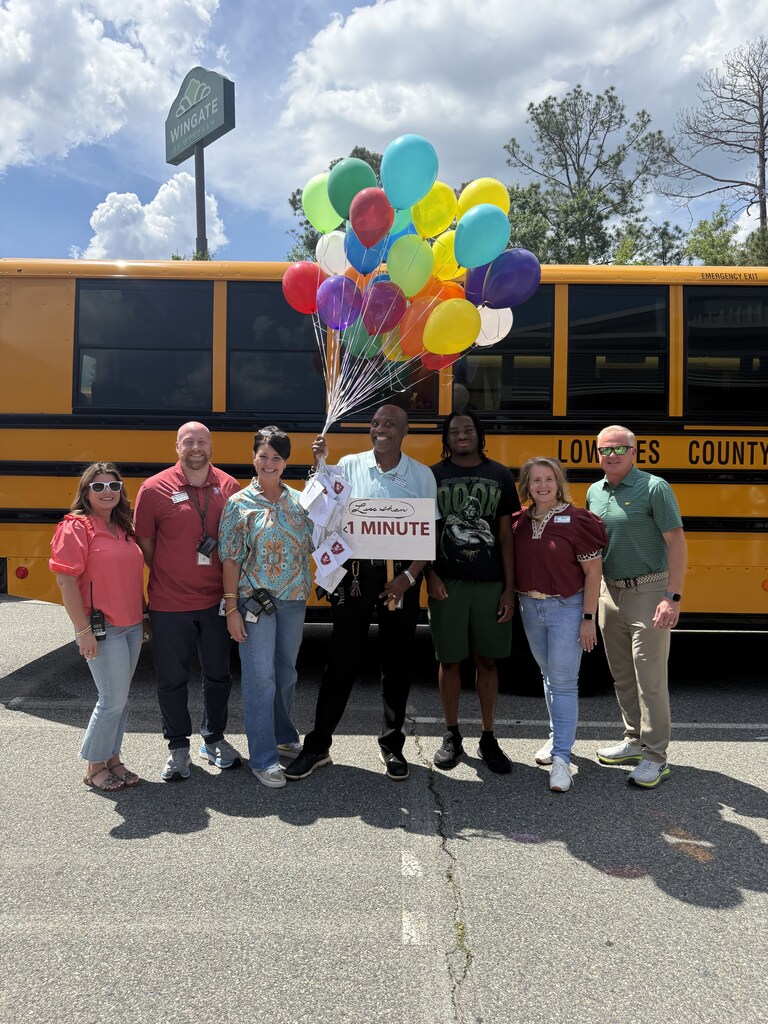 Mr. Walker with his balloons, his son, and the administrators