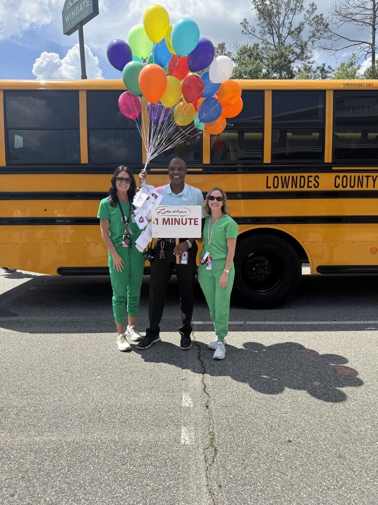 Mr. Walker with the school nurses and his balloons