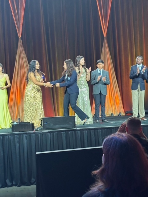Maria receiving award