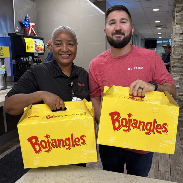 Mr. Swilley and Ms. Debra posing with biscuits from Bojangles