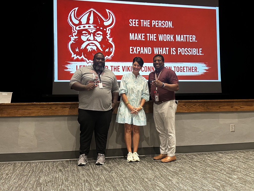 Assistant principal with two teachers who won Hog N Bones prizes