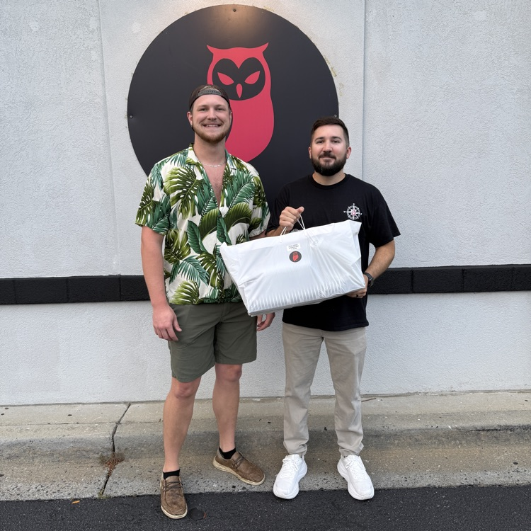 Mr. Swilley posing with coffee and Red Owl employee