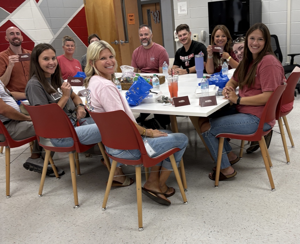 Social studies teachers enjoying lunch and gifts from Outback