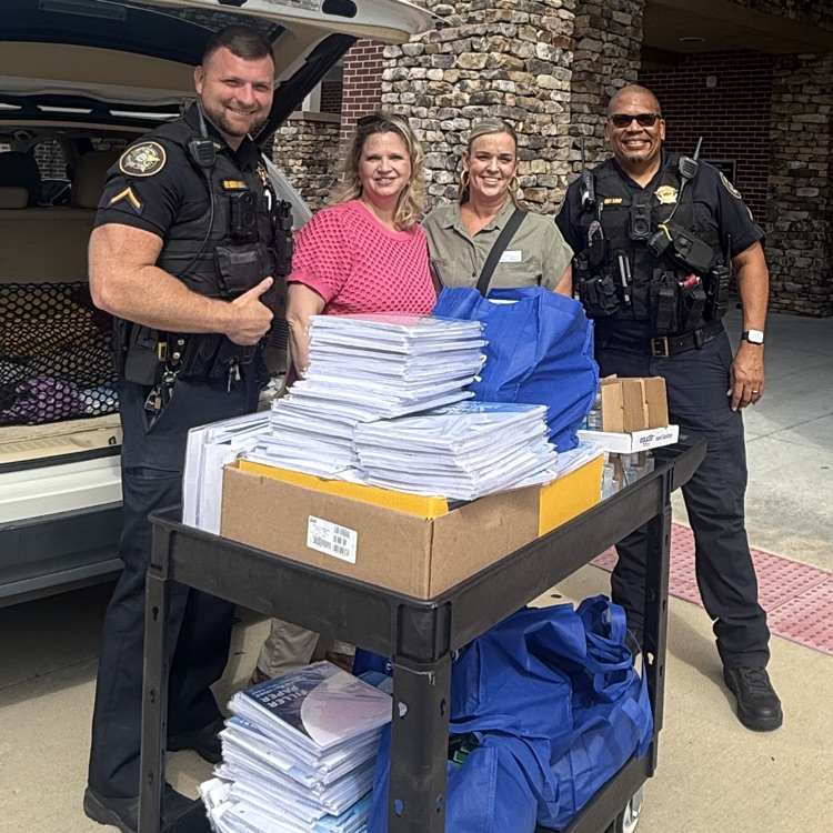 admin and SROs posing with donations