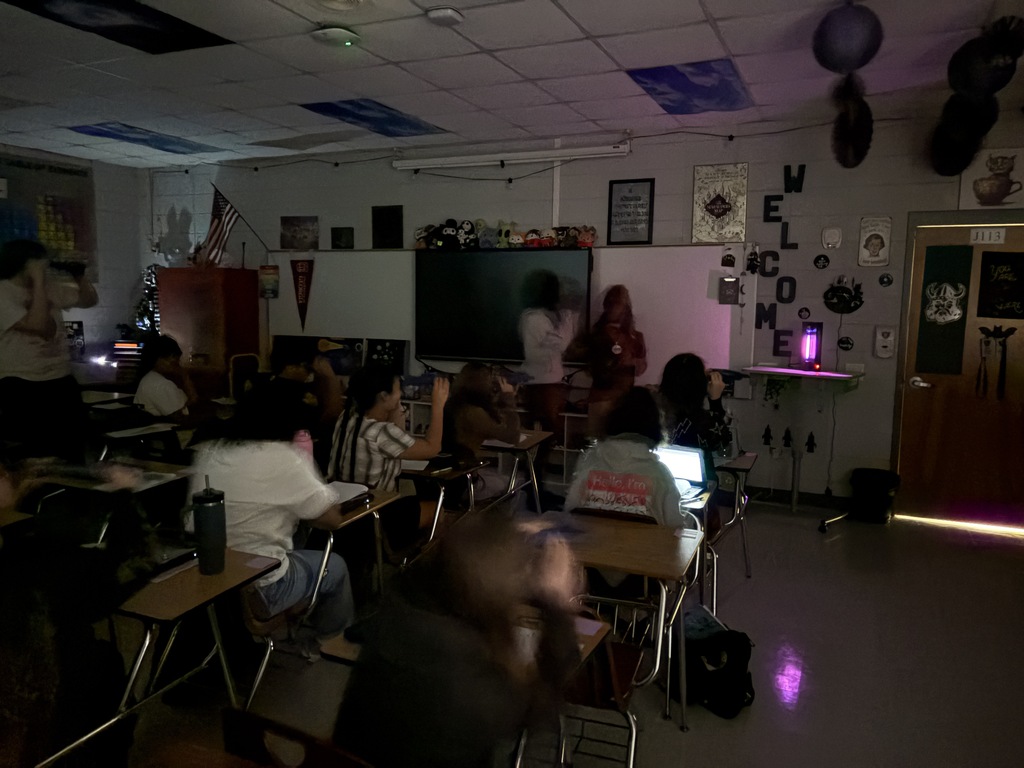 Astronomy students using spectrometry to identify mystery gases in glowing tubes.