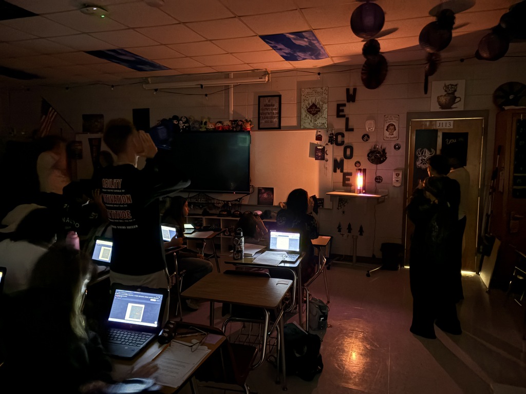 Astronomy students using spectrometry to identify mystery gases in glowing tubes.