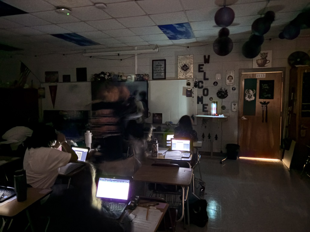 Astronomy students using spectrometry to identify mystery gases in glowing tubes.