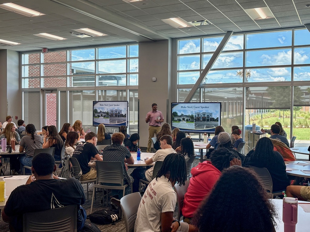 Mr. Steel speaking with economics students