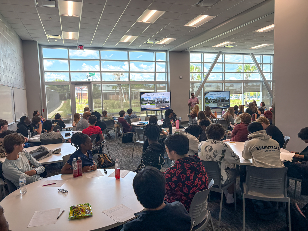 Mr. Steel speaking with economics students