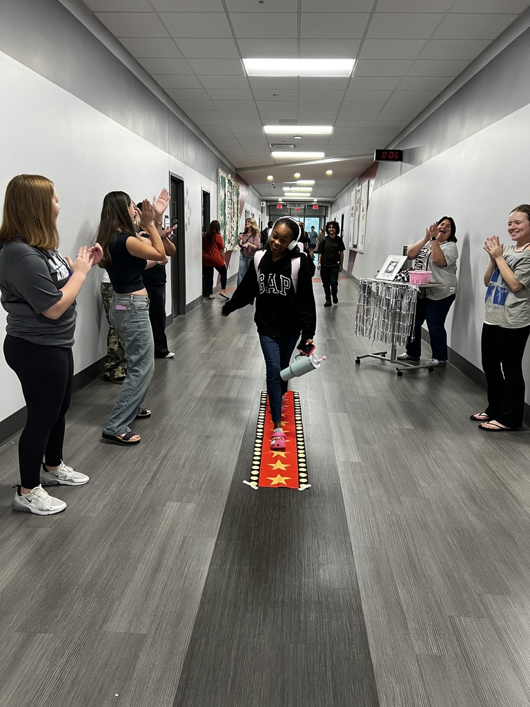 Student walking the red carpet for a prize