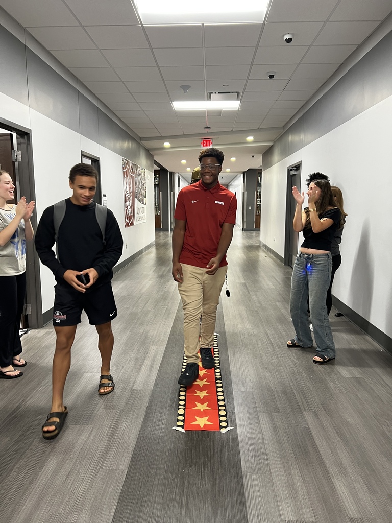 Students walking the red carpet for a prize