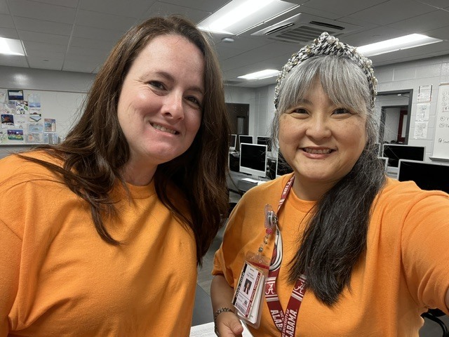 Two teachers dressed in orange