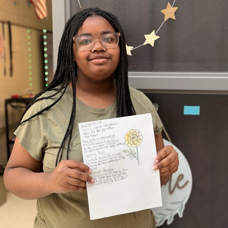 student holding work 