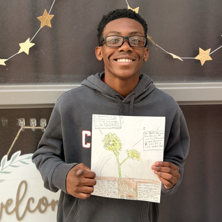 student holding work 