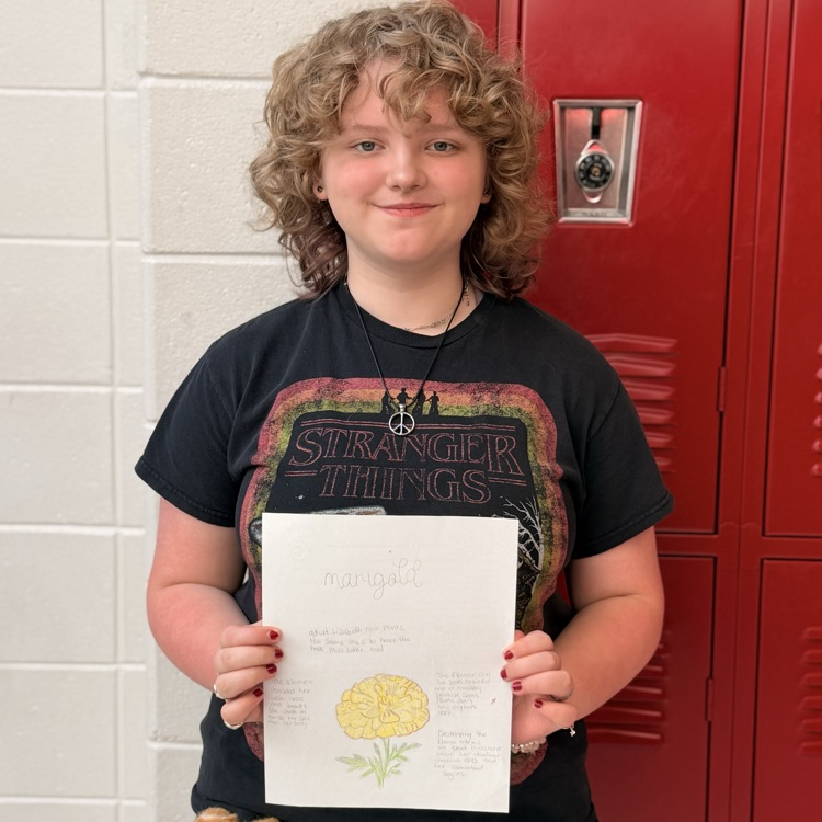student holding work 
