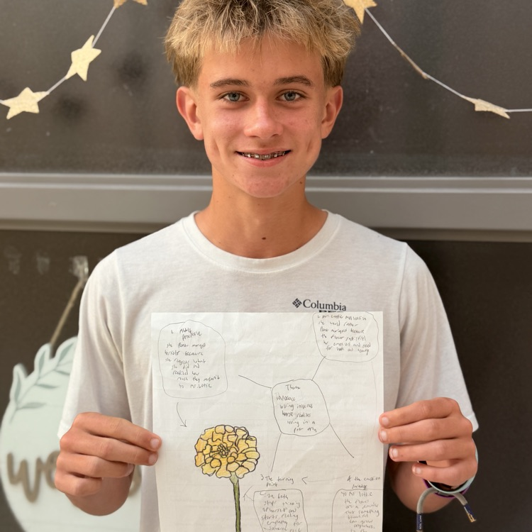 student holding work 