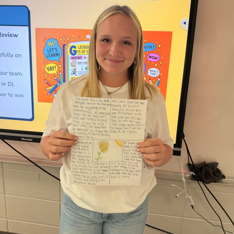 student holding work 