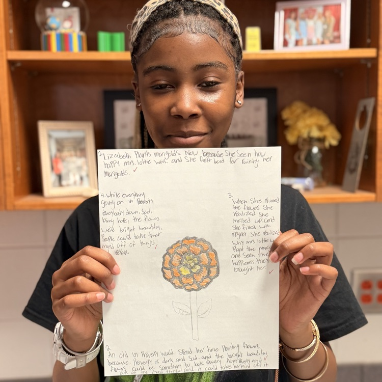 student holding work 
