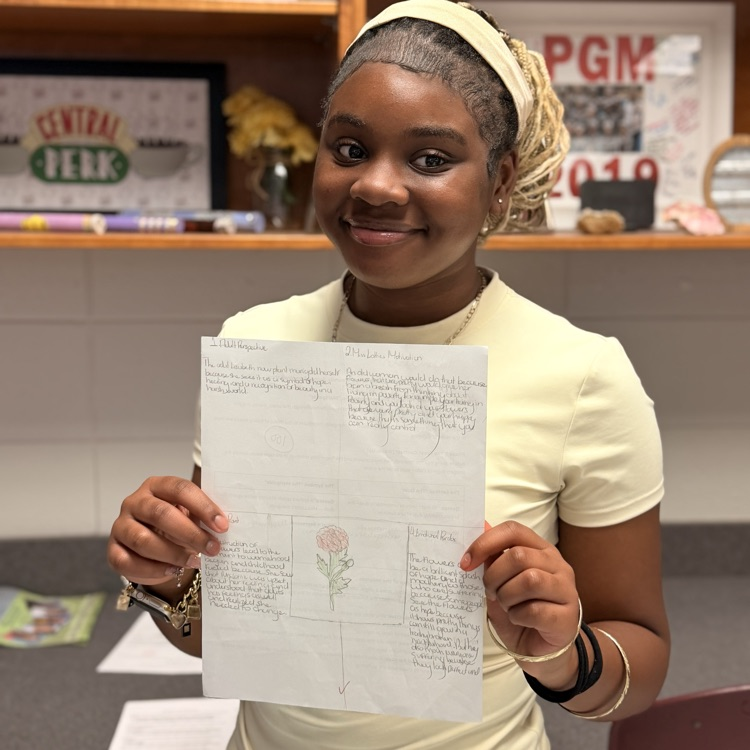 student holding work 